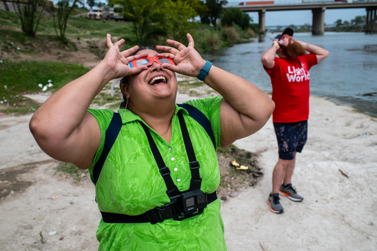 Amerika Garcia uses a pair of protective lenses to look at the sun during a total solar eclipse in Piedras Negras, Mexico