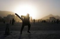 Hikmatullah, 30, plays cricket at a playground in Kabul