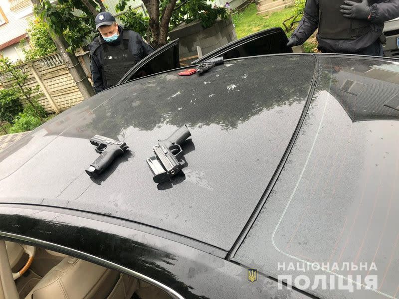 Police officers detain men suspected of taking part in a recent armed conflict in Brovary