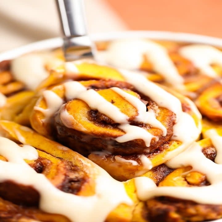 Cinnamon rolls with gooey white icing all over