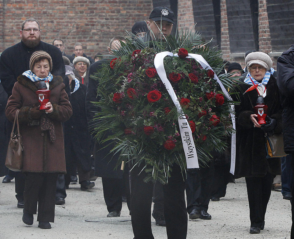 Auschwitz survivors lay a wreath at the former Nazi death camp's Executions wall in Oswiecim, Poland, on Monday, Jan. 27, 2014, to mark 69 years since the Soviet Red Army liberated the camp. Israeli lawmakers and government officials are to attend anniversary observances later in the day. The Nazis killed some 1.5 million people, mostly Jews at the camp during World War II. (AP Photo/Czarek Sokolowski)