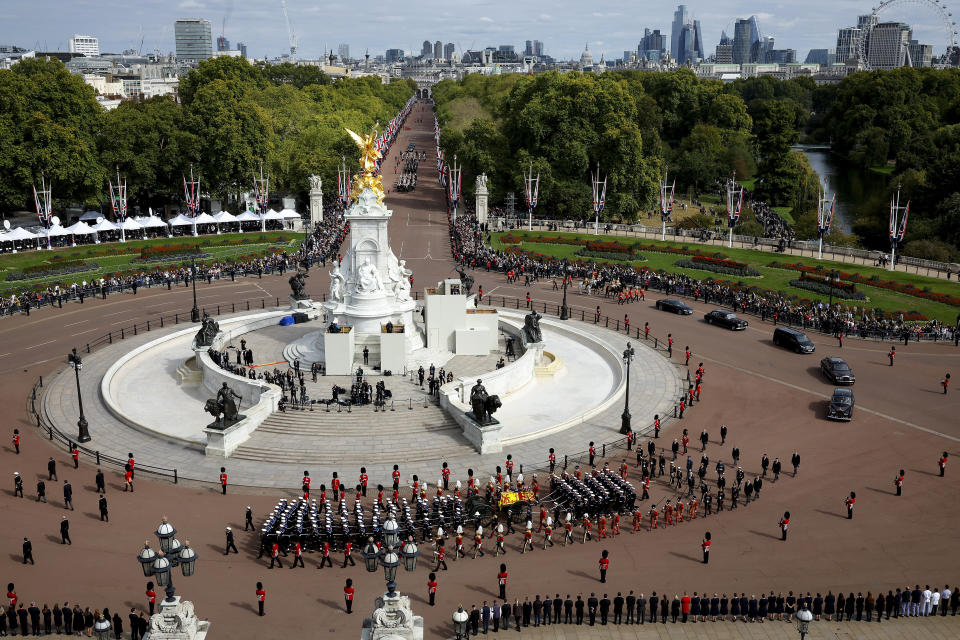 Queen Elizabeth II's funeral cortege borne on the State Gun Carriage of the Royal Navy travels along The Mall and around the Queen Victoria Memorial in London, Monday, Sept. 19, 2022. (Chip Somodevilla/Pool Photo via AP)