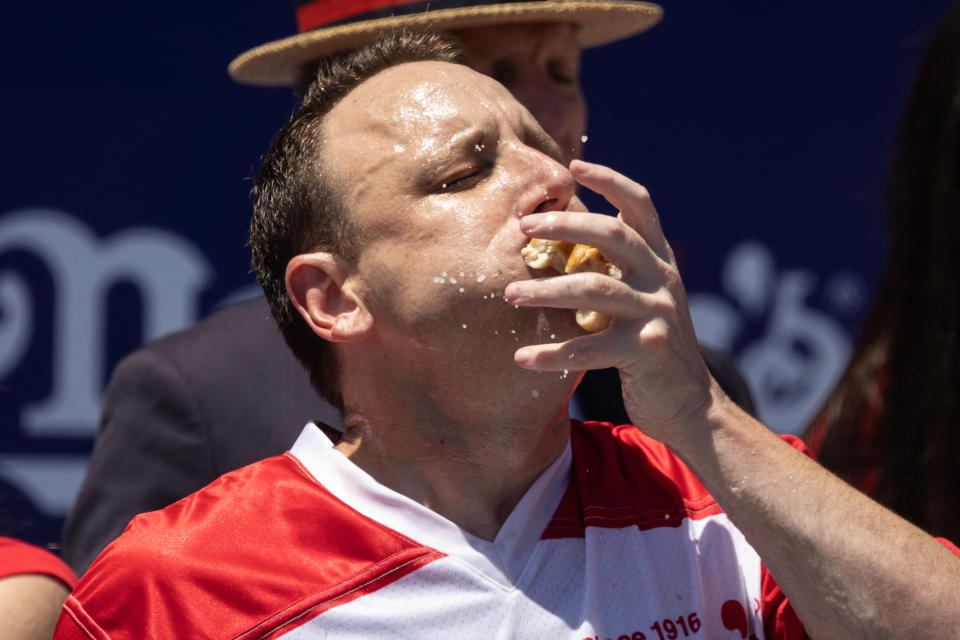 Joey Chestnut eats as he competes for his 15th championship title during the 2022 Nathan's Famous Fourth of July hot dog eating contest on Coney Island on July 4, 2022 in New York. - Joey Chestnut won by eating 63 hot dogs and buns. (Photo by Yuki IWAMURA / AFP) (Photo by YUKI IWAMURA/AFP via Getty Images)