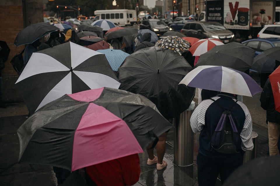 People wait for the bus as trains get cancelled due to flooding from heavy rains on Friday, Sept. 29, 2023, in the Brooklyn borough of New York. (AP Photo/Andres Kudacki)