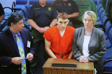 Nikolas Cruz appears via video monitor with Melisa McNeill, his public defender, at a bond court hearing after being charged with 17 counts of premeditated murder, in Fort Lauderdale, Florida. REUTERS/Susan Stocker/Pool