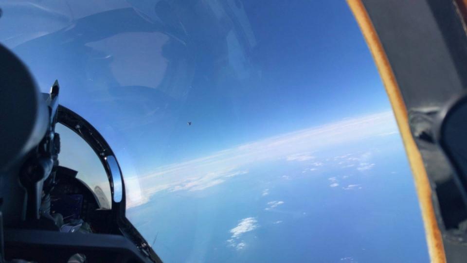 A navy pilot looks out at a "cube-shaped" UFO, in one instance of the kind of UAP the Airborne Object Identification and Management Synchronization Group (AOIMSG) will study.