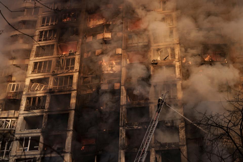 Firefighters extinguish fires in an apartment building after being hit by shelling in Kyiv, Ukraine, Tuesday, March 15, 2022.