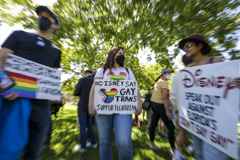 Glendale, CA - March 22: Disney's LGBTQ employees Try Desa, left, Tiffany Cooper and Nicole Quadros rally against their CEO Bob Chapek's handling of the staff controversy over Florida's "Don't Say Gay" bill, at Bette Davis Picnic Area on Tuesday, March 22, 2022 in Glendale, CA. (Irfan Khan / Los Angeles Times)