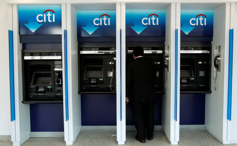 FILE PHOTO: A man uses a Citibank automated teller machine at a branch in Washington