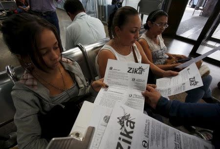 Colombian women listen as a health worker distributes information how to prevent the spread of the Zika virus, at the transport terminal in Bogota, Colombia January 31, 2016. REUTERS/John Vizcaino