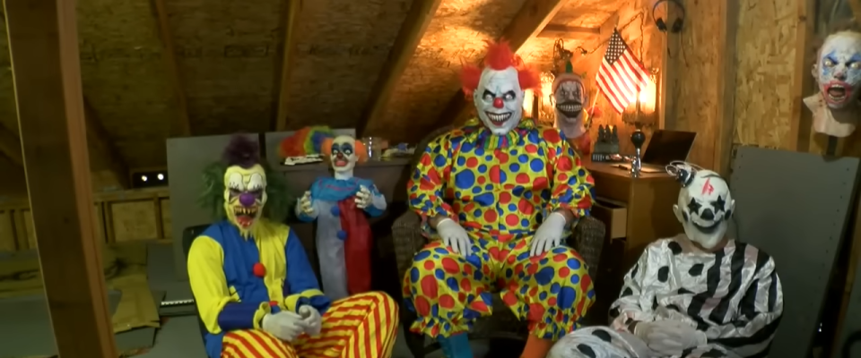 Group of clowns in costumes being interviewed by 10News in an attic, discussing their non-threatening intentions