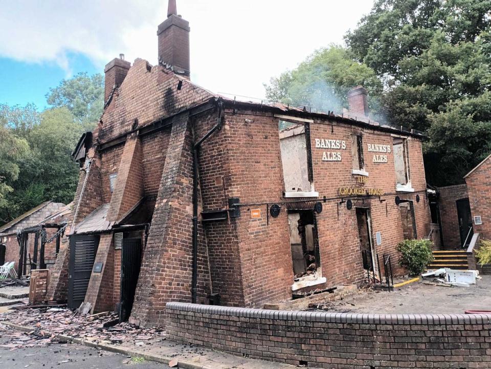 The pub had been shored up on one side (PA)