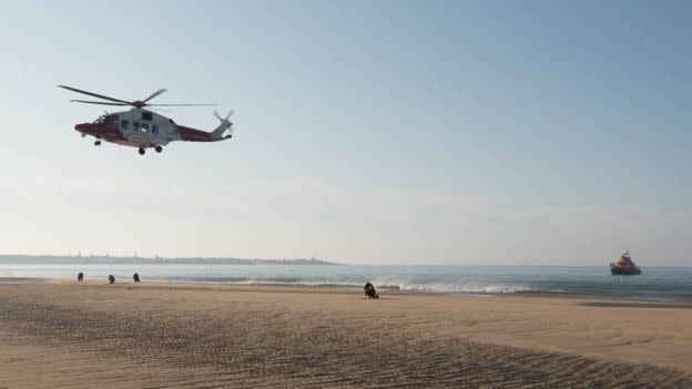 A helicopter hovering over the Aberdeenshire beach where the incident unfolded on Monday. (RNLI Fraserburgh)