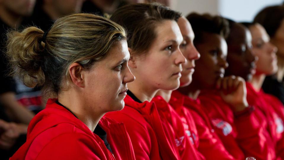 Canadian women's national soccer team captain Christine Sinclair, left, and goalkeeper Erin McLeod, second left, sit with their teammates during a celebration to send-off Olympic athletes and coaches to the 2012 Summer Olympic and Paralympic Games, in Vancouver, B.C., on Monday, June 18, 2012. (AP Photo/DARRYL DYCK, Canadian Press)