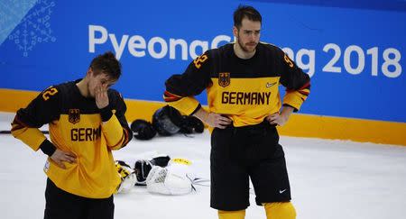 Ice Hockey - Pyeongchang 2018 Winter Olympics - Men's Final Game - Olympic Athletes from Russia v Germany - Gangneung Hockey Centre, Gangneung, South Korea - February 25, 2018 - Brooks Macek and Marcel Noebels of Germany react after their overtime loss. REUTERS/Brian Snyder