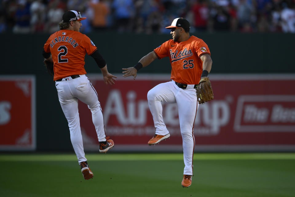 Baltimore Orioles right fielder Anthony Santander (25) and shortstop Gunnar Henderson (2) celebrate after a baseball game against the Philadelphia Phillies, Saturday, June 15, 2024, in Baltimore. The Orioles won 6-2. (AP Photo/Nick Wass)