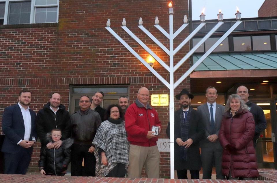 Toms River Mayor Mo Hill and Township Council members celebrate the township's menorah lighting for Hanukkah.