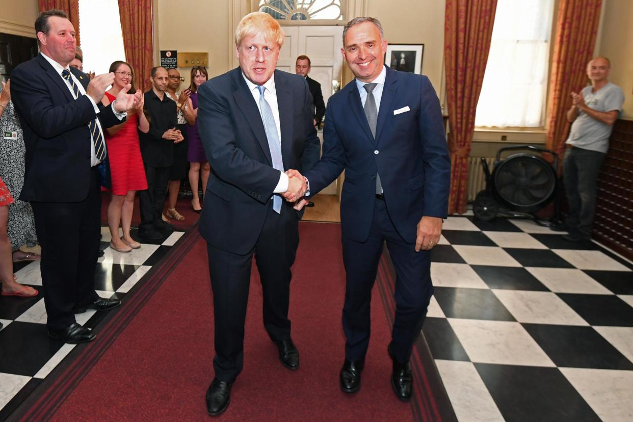 Boris Johnson shakes hands with Mark Sedwill as he is clapped into No 10 after winning the election last year: Getty