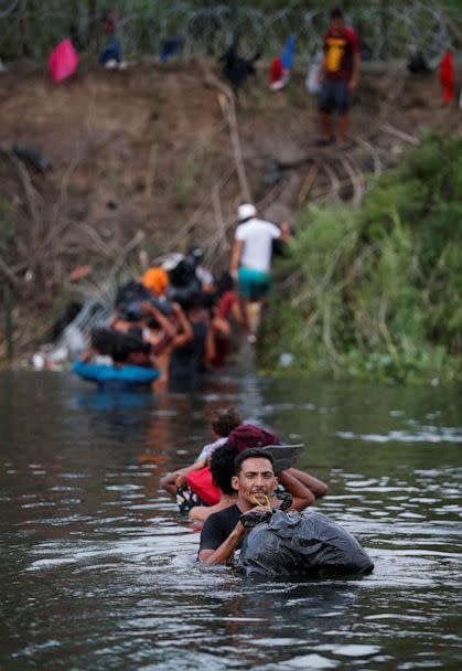 PHOTO: Migrants cross the Rio Bravo river to turn themselves in to U.S. Border Patrol agents before Title 42 ends, in Matamoros, Mexico May 10, 2023. (Daniel Becerril/Reuters)