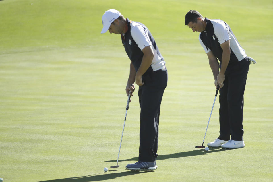 Europe's Rory McIlroy, right, and Europe's Sergio Garcia putt on the 6th green during a practice round for the 2018 Ryder Cup in Saint-Quentin-en-Yvelines, outside Paris, France, Wednesday, Sept. 26, 2018. The 42nd Ryder Cup will be held in France from Sept. 28-30, 2018 at Le Golf National. (AP Photo/Matt Dunham)