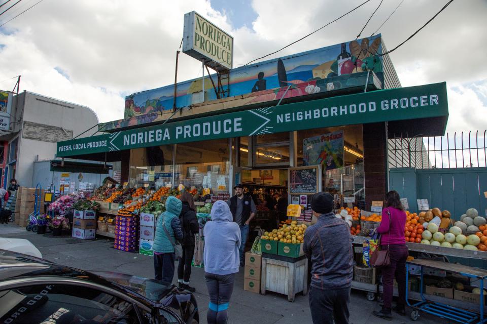 San Francisco residents line up outside a small local grocery store in the Sunset District, hours after Mayor London Breed issued a citywide directive ordering people to shelter in place for the next three weeks. A manager at the small store stood by the door doing crowd control, allowing only one person to enter at a time on Monday, March 16, 2020.