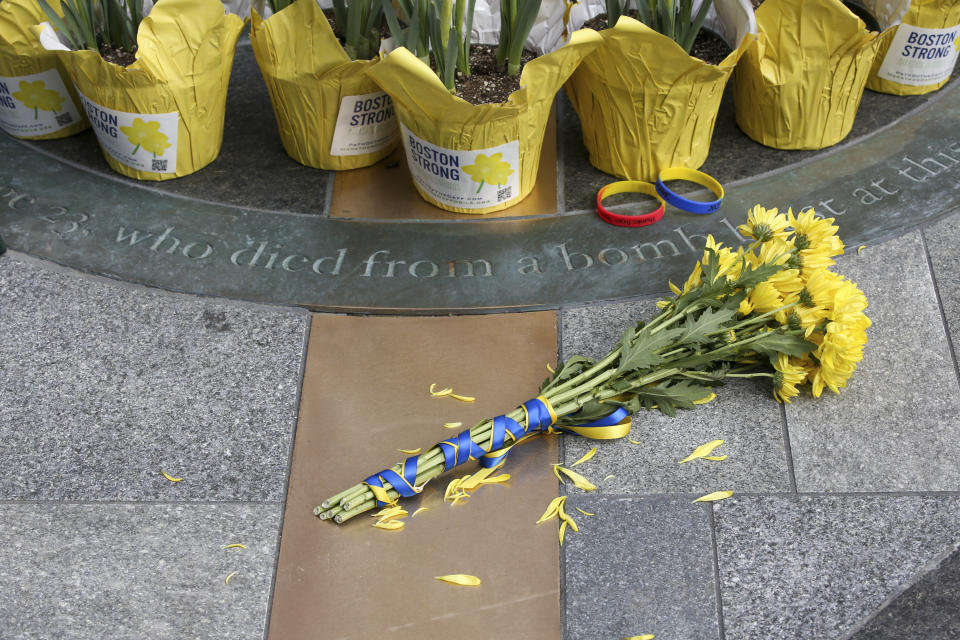 Flowers are placed at a memorial for victims of the 2013 Boston Marathon bombing, Saturday April 15, 2023, in Boston. (AP Photo/Reba Saldanha)