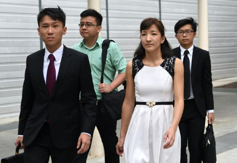 Australian Japanese Ai Takagi (front R), 23, and her Singaporean husband Yang Kaiheng (back L), 27, and their lawyer Choo Zheng Xi (front at L) leave the state court after a trial in Singapore on March 7, 2016