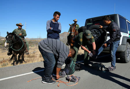 U.S. Border Patrol agents from Boulevard Station inspect three men near Jacumba, California, U.S., November 14, 2016. REUTERS/Mike Blake