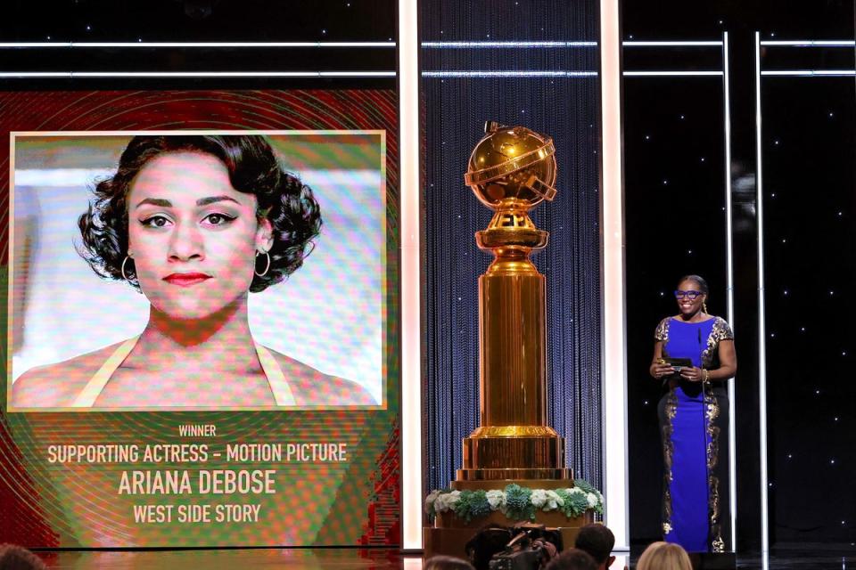 HFPA Grantee and Founder and Executive Director of Kids in the Spotlight Tige Charity presenting the Best Supporting Actress in a Motion Picture Award onstage during the 79th Annual Golden Globe Awards (HFPA/AFP via Getty Images)