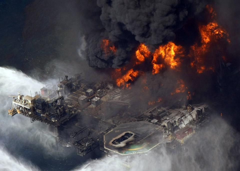 FILE - A plume of smoke rises from fires on BP's Deepwater Horizon offshore oil rig in the Gulf of Mexico on April 21, 2010. A new National Academy of Science study says that 13 years after a massive BP oil spill fouled the Gulf of Mexico, regulators and industry have reduced some risks in deep water exploration in the gulf but some troublesome safety issues persist. (AP Photo/Gerald Herbert, File)