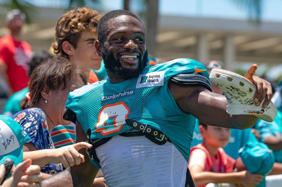 NFL Miami Dolphins cornerback Noah Igbinoghene (9) asks for a sharpie to sign a fan’s shoe during Dolphins Training Camp at Baptist Health Training Complex in Miami Gardens, Florida on Wednesday, August 3, 2022.