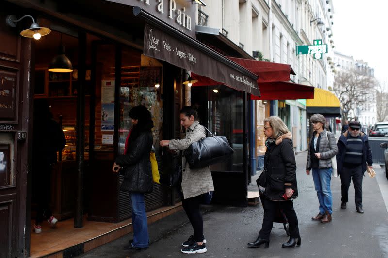 People line up outside a bakery in Paris
