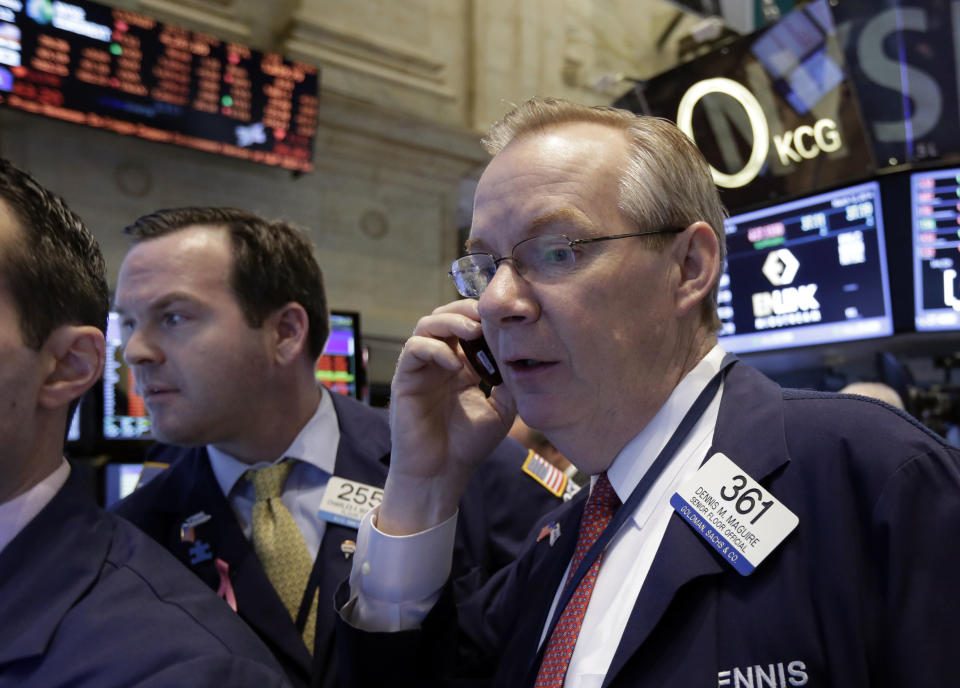 Trader Dennis Maguire, right, works on the floor of the New York Stock Exchange Wednesday, March 12, 2014. U.S. stocks are heading lower for the third day in a row as investors continue to worry about slower growth in China and the lingering tensions in Ukraine. (AP Photo/Richard Drew)