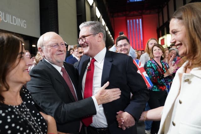 Labour leader Sir Keir Starmer and his wife Victoria are greeted by Neil Kinnock at the Tate Modern after securing victory