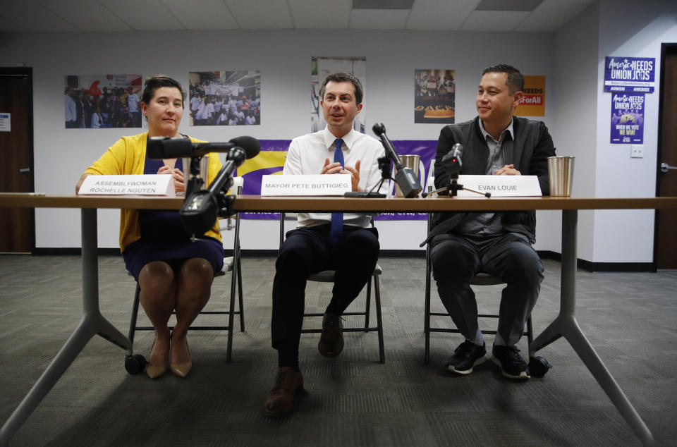 Democratic presidential candidate South Bend, Ind., Mayor Pete Buttigieg, center, speaks beside Nevada Assemblywoman Rochelle Nguyen, left, and Evan Louie at a town hall event with Asian American and Pacific Islander voters Friday, Dec. 20, 2019, in Las Vegas. (AP Photo/John Locher)