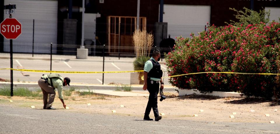 Yellow placards that typically mark expended shell casings dot the street at Monday's crime scene at the 1000 block of South Zinc Street.
(Photo: Bill Armendariz - Headlight Photo)