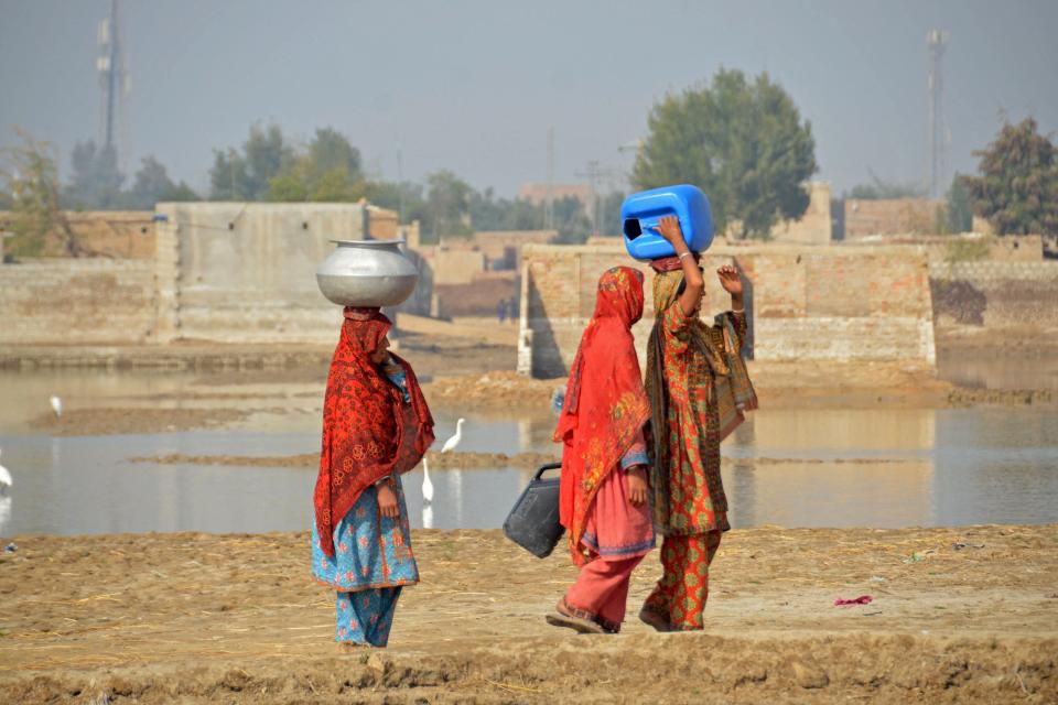 Flood-affected residents walk to collect water in the flood-hit area of Dera Allah Yar in Jaffarabad district of Balochistan province on Jan. 9, 2023. The UN chief called on Jan. 9 for "massive investments" to help Pakistan recover from last year's devastating floods and better resist climate change, as financial pledges poured in.