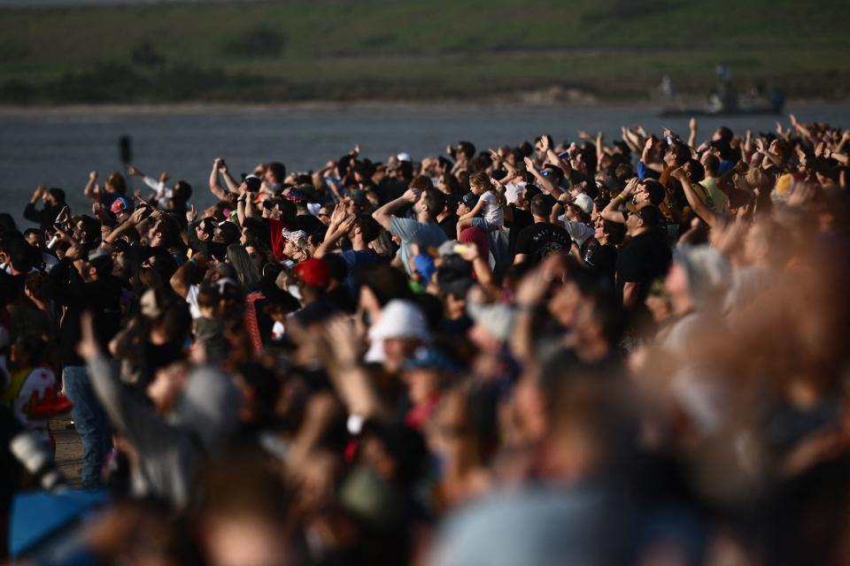 Spectators watch the first test flight of SpaceX's Starship on April 20, 2023