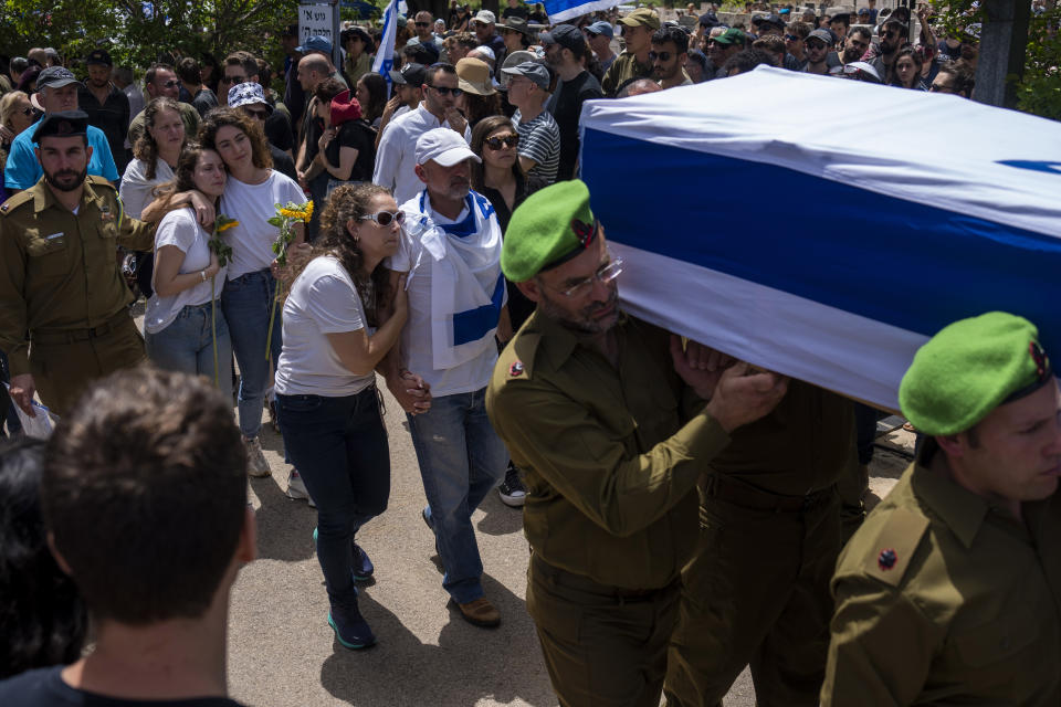 FILE - Family follow in grief as soldiers carry the casket of Israeli reserve Major Dor Zimel at his funeral in Even Yehuda, Israel, Monday, April 22, 2024. Zimel, 27, died after Iran-backed Lebanese militant Hezbollah group fired a volley of rockets and drones on northern Israel. The Hezbollah group is introducing new tactics and weapons against Israel as the war in Gaza drags on. In mid-May 2024, Hezbollah has used a drone equipped with missiles to attack an Israeli post as well as an explosive drone to hit its deepest target so far since the clashes began seven months ago. (AP Photo/Ariel Schalit, File)