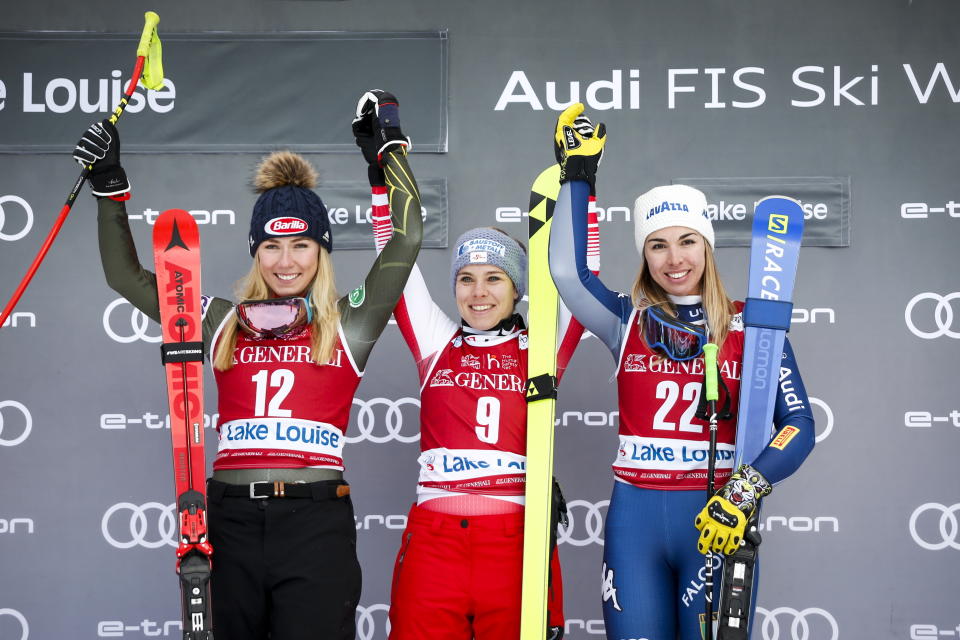 Austria's Nicole Schmidhofer, center, celebrates her win with second place finisher Mikaela Shiffrin, left, of the United States, and third place finisher Italy's Francesca Marsaglia, following the women's World Cup downhill ski race, Saturday, Dec. 7, 2019 in Lake Louise, Alberta. (Jeff McIntosh/The Canadian Press via AP)