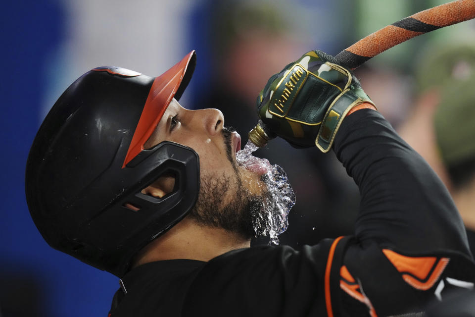 Baltimore Orioles' Anthony Santander drinks from a hose as he celebrates his solo home run against the Toronto Blue Jays during the sixth inning of a baseball game Friday, May 19, 2023, in Toronto. (Chris Young/The Canadian Press via AP)