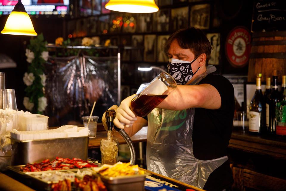 Gerry Gonzalez mixes a drink for a customer at Julius'. (Julius Constantine Motal / NBC News)