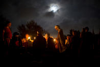 <p>Israeli and Russian members of knight clubs wearing medieval costumes eat dinner two nights before marching 27 kilometers (17 miles) to the reenactment of the Battle of Hattin from the ancient Israeli city of Zippori to Horns of Hattin, northern Israel, July 2, 2015. (Photo: Oded Balilty/AP) </p>