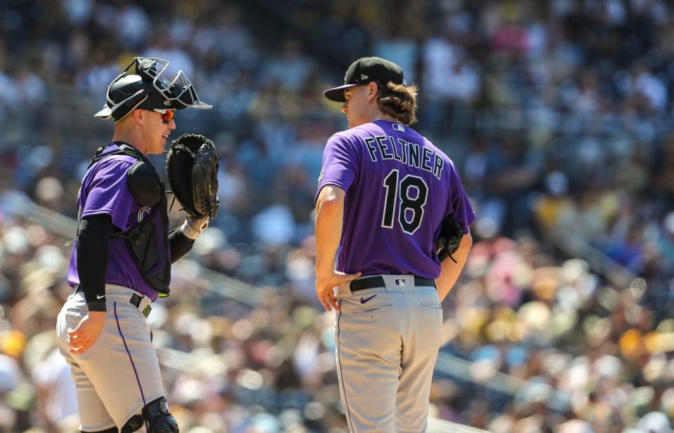 Colorado Rockies catcher Brian Serven (6) approaches the mound to talk with starting pitcher Ryan Feltner (18) during a game at Petco Park in San Diego, Calif., Saturday, June 11, 2022. 