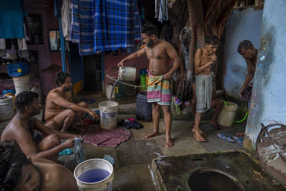 Migrant workers wash their clothes near a well which serves as a bathing area outside their rented accommodations in Dharavi, one of Asia's largest slums, in Mumbai, India, Wednesday, May 3, 2023. According to the World Bank, while India has 18% of the world's population, it has only 4% of its water. That makes it one of "the most water-stressed" countries in the world, the international development organization says. (AP Photo/Dar Yasin)