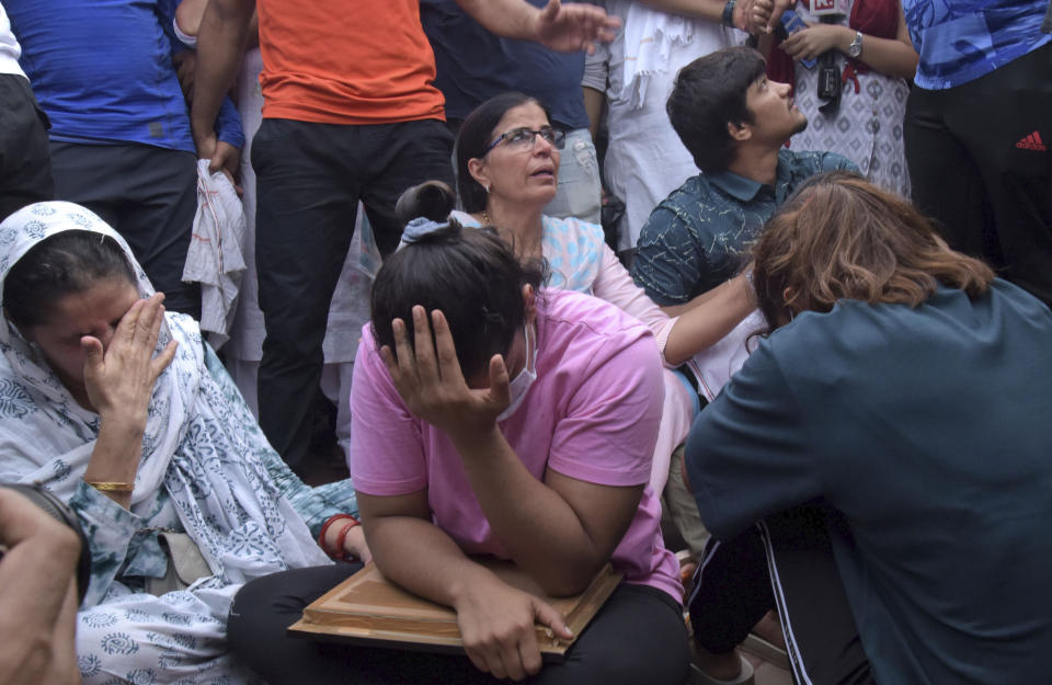 FILE- Sakshi Malik, an Indian wrestler who won a bronze medal at the 2016 Summer Olympics, sits with fellow wrestlers by the banks of the river Ganges in Haridwar, India, May 30, 2023. New Delhi police filed charges Thursday of sexual harassment and outraging the modesty of six female athletes by Indian wrestling federation president Brij Bhushan Sharan Singh at the end of their investigation. If convicted, Singh faces a maximum of five years in prison. He denies the allegations. (AP Photo, File)