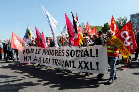 Demonstrators hold a banner reading "For Social Progress, No to the XXL labour law" as they attend a demonstration against the government's labour reforms in Lyon, France, September 21, 2017. REUTERS/Robert Pratta