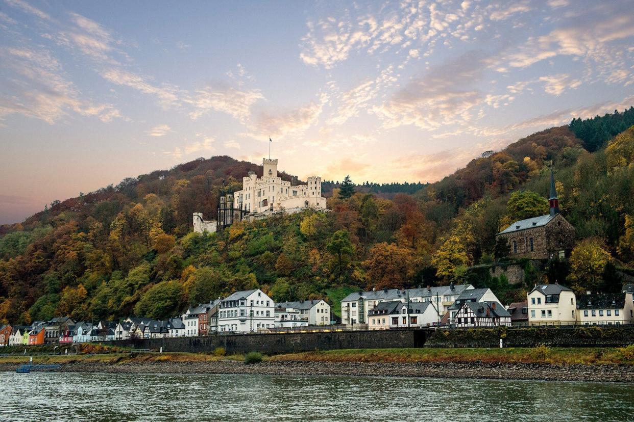 View from river cruise in Europe showing village landscape and green tree-filled hills