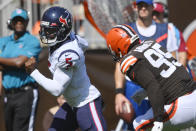 Houston Texans quarterback Tyrod Taylor (5) rushes for a 15-yard touchdown against Cleveland Browns defensive end Myles Garrett (95) during the first half of an NFL football game, Sunday, Sept. 19, 2021, in Cleveland. (AP Photo/David Richard)