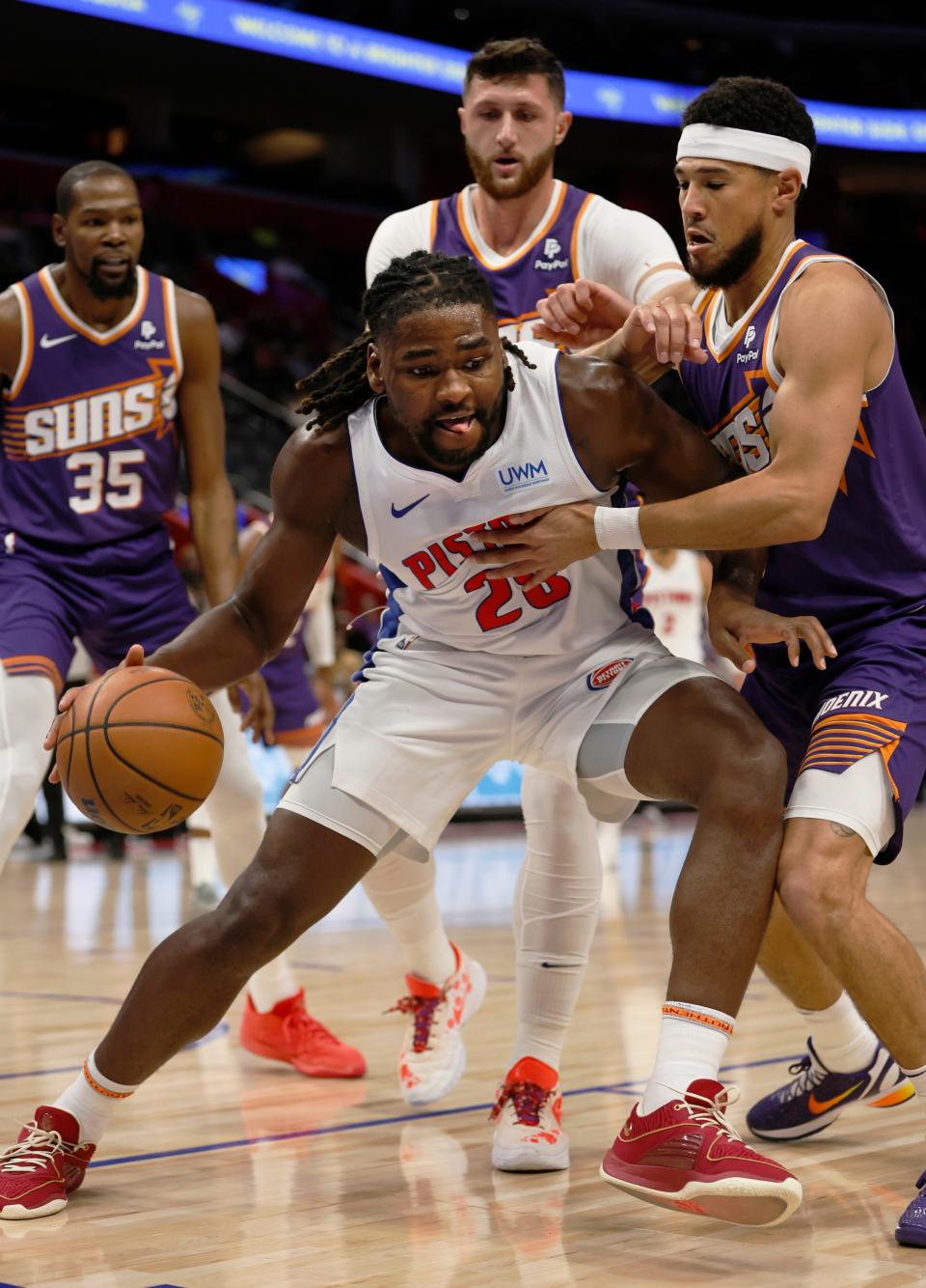 Pistons center Isaiah Stewart drives against Suns guard Devin Booker, right, during the first half of a preseason game on Sunday, Oct. 8, 2023, at Little Caesars Arena.